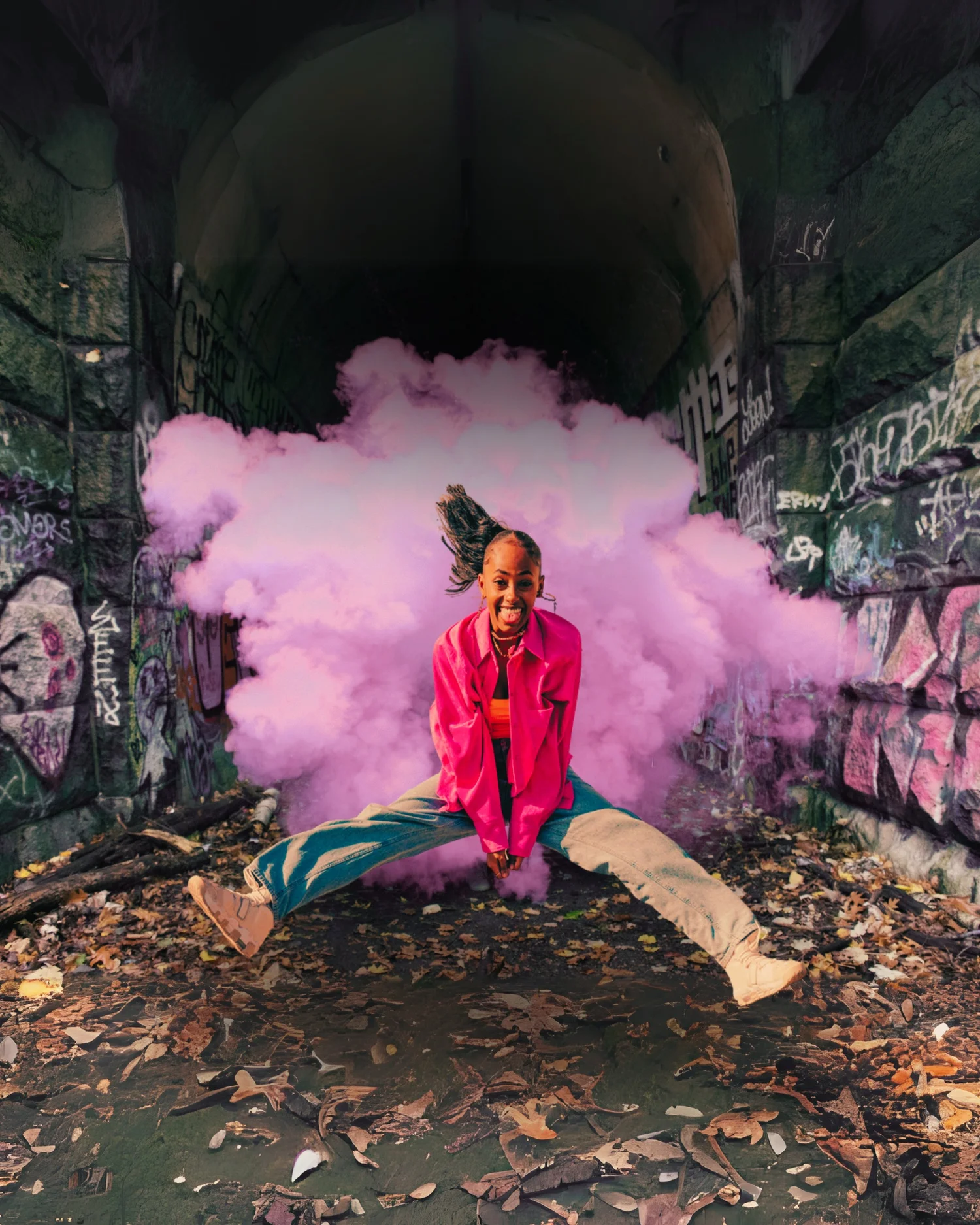Person in pink standing in a tunnel filled with billowing pink smoke